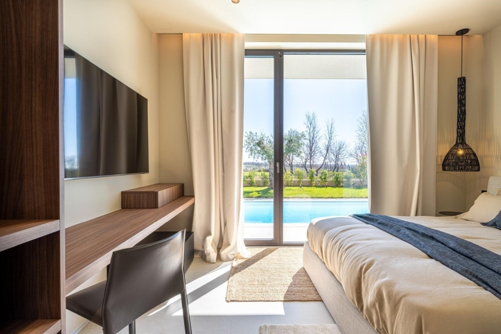 Bedroom with a direct view of the garden and pool