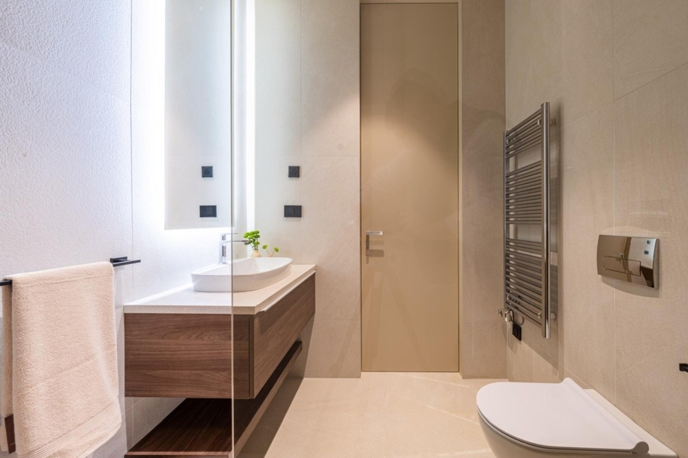 Bright bathroom with sink and towel radiator