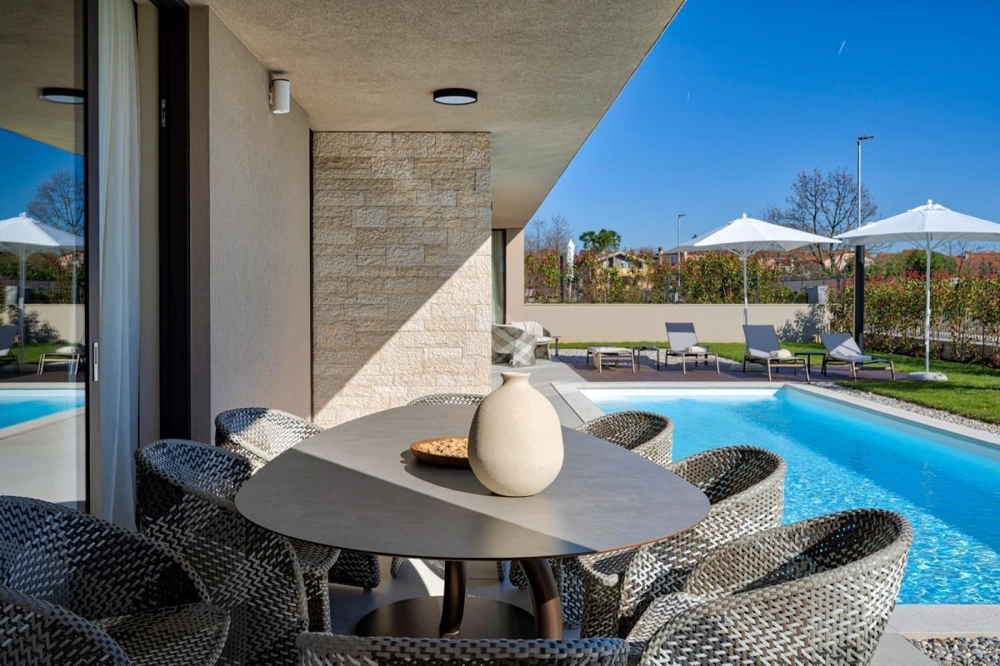 Modern terrace with dining table and pool