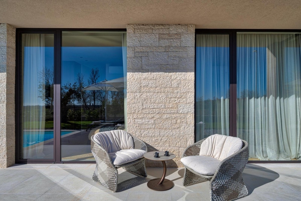 Covered patio with seating area and sliding glass doors