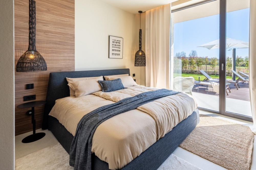 Bedroom with access to the terrace and pool view