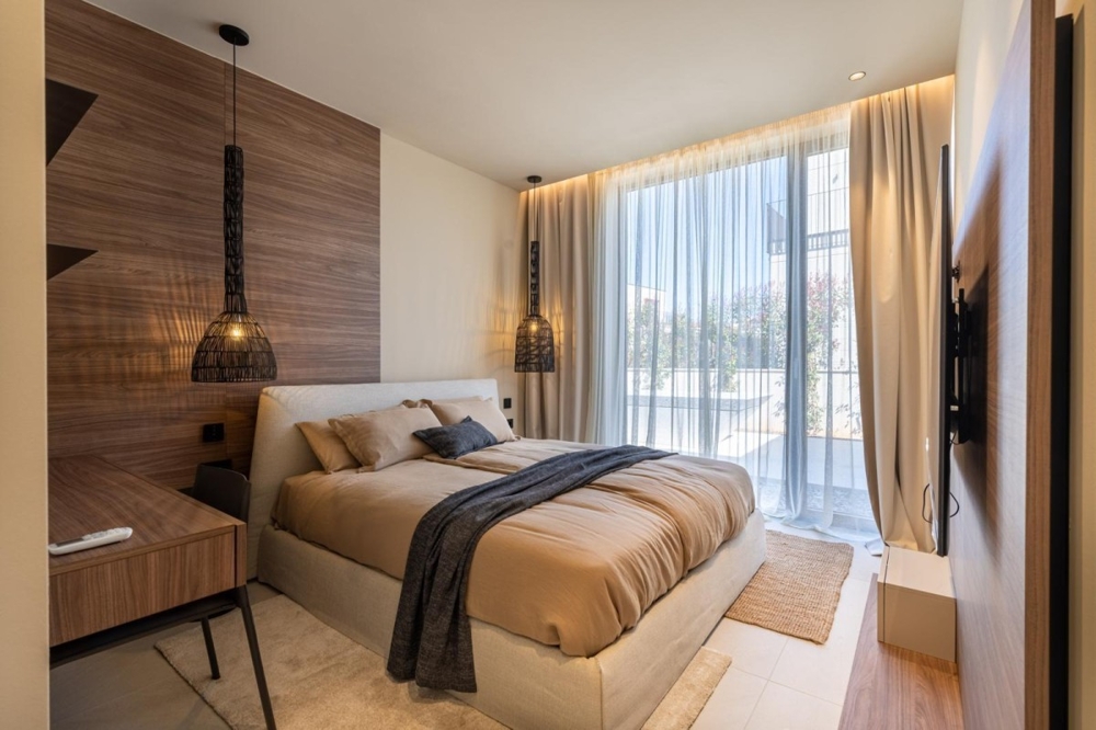 Bedroom with large windows and curtains