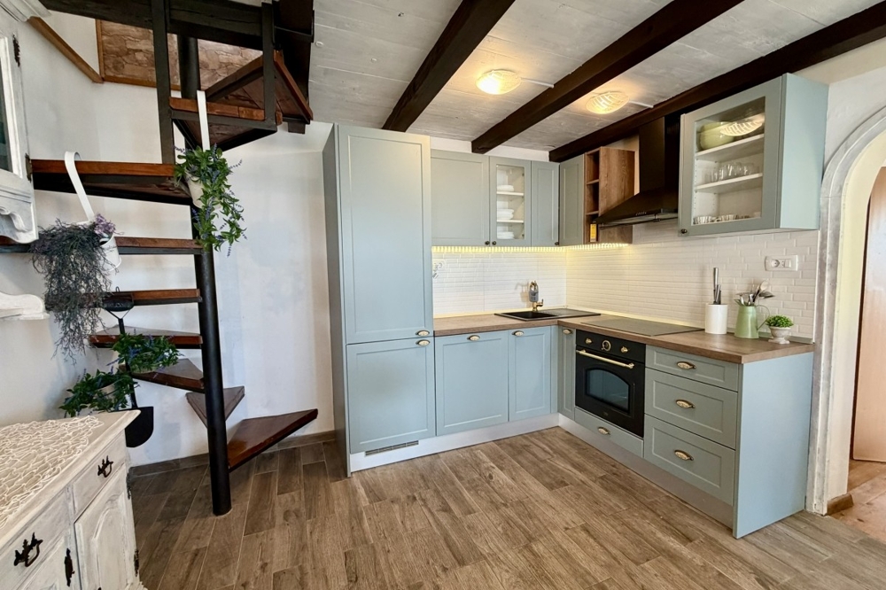 Open kitchen with built-in furniture and wooden stairs