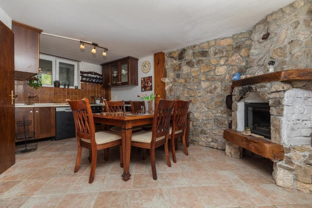 Dining area with rustic fireplace and stone decor