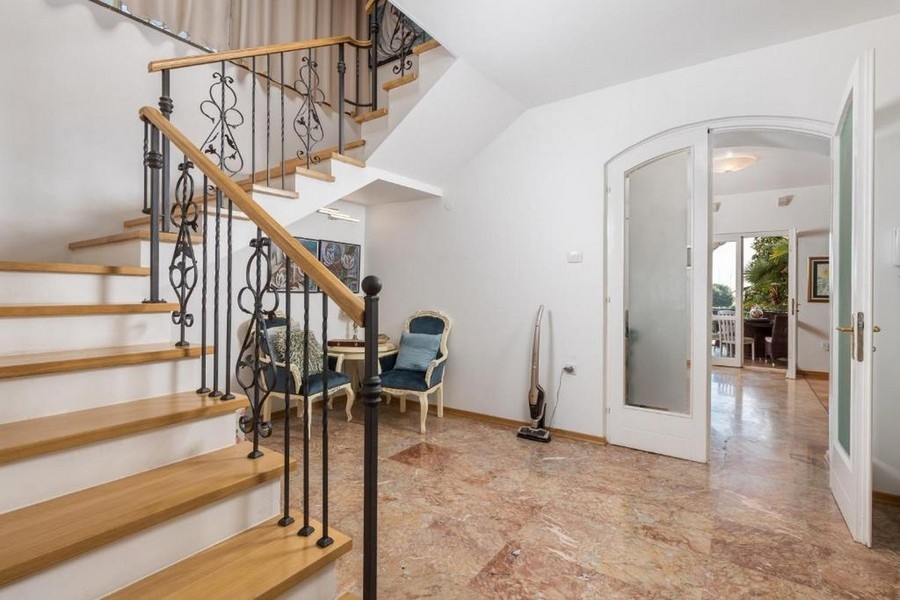 Entrance area with stairs and marble floor