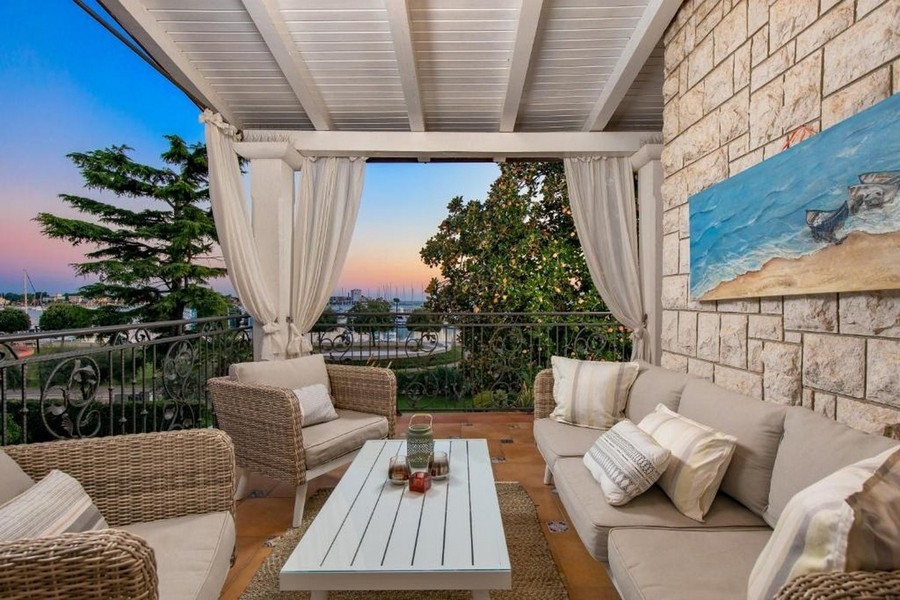 Balcony with lounge furniture and sea views at sunset