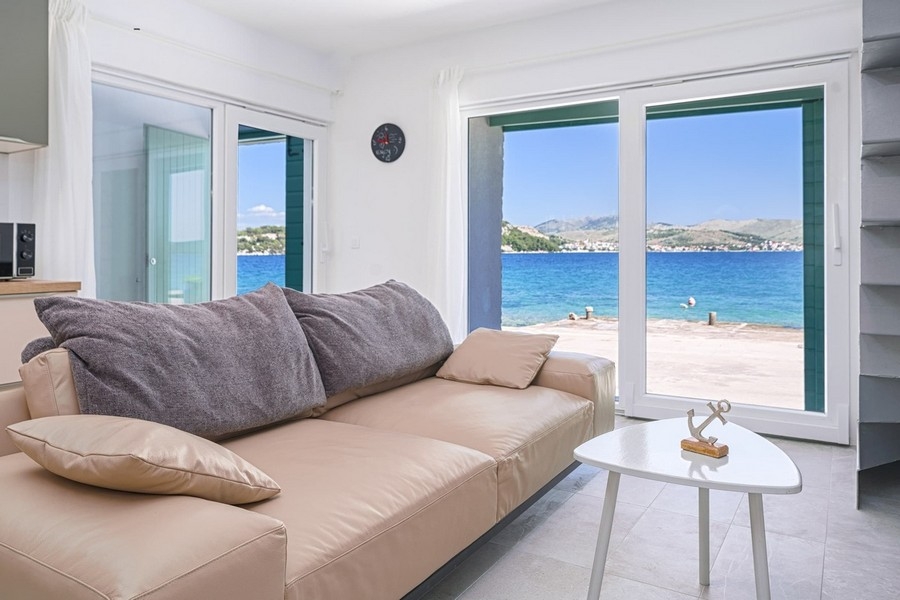 Living room with sofa and direct sea views