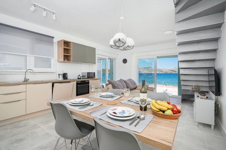 Open plan living and dining area with kitchen and sea views