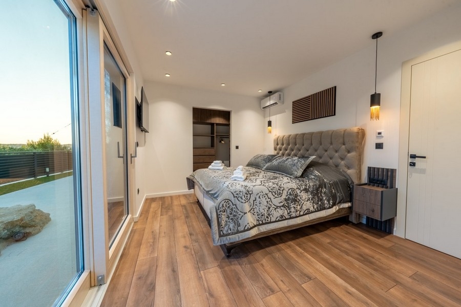 Bedroom with terrace access and views of the greenery