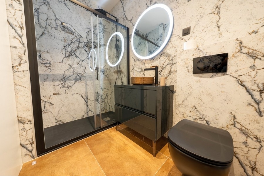 Modern bathroom with shower and designer furnishings