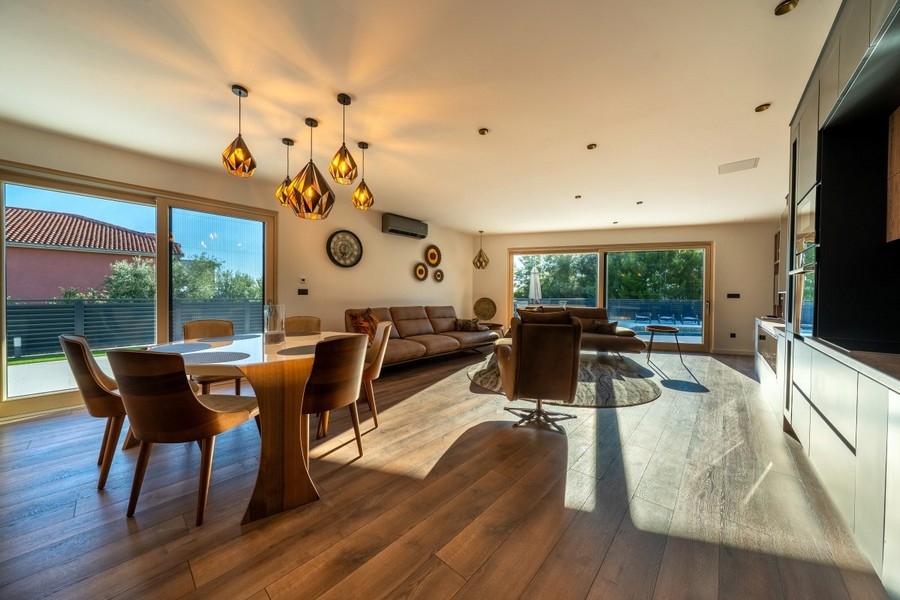 Open living and dining area with large window fronts