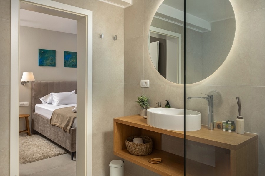 Bathroom with sink and round mirror