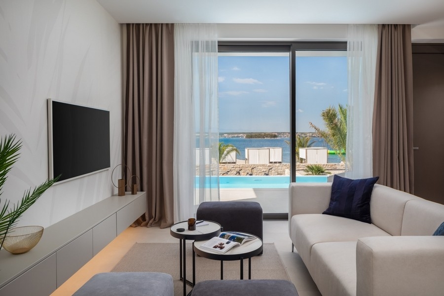 Living room overlooking pool and sea