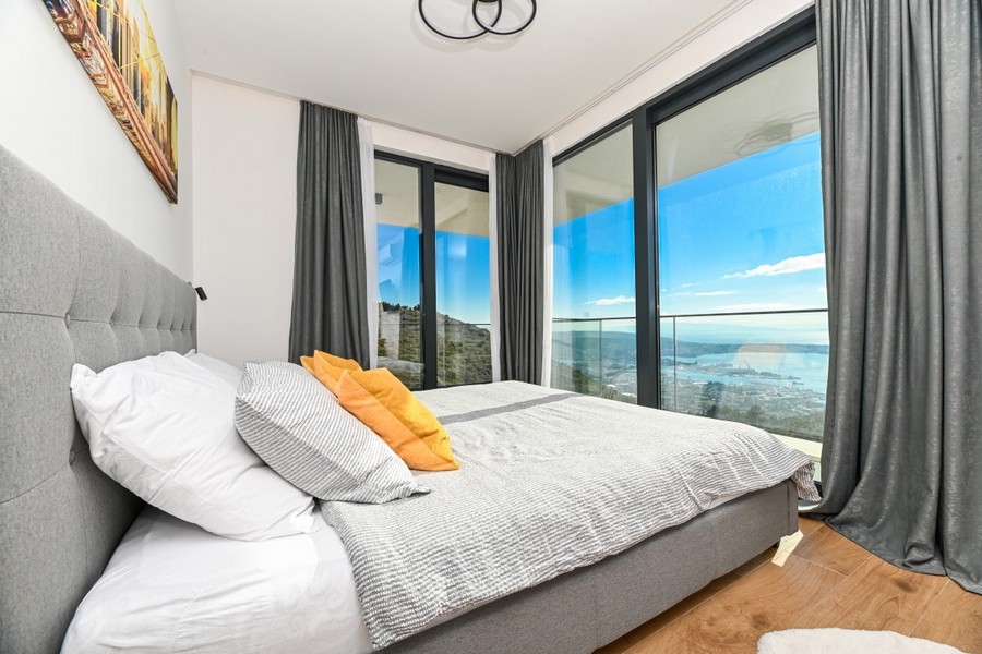 Bedroom with panoramic windows and sea views
