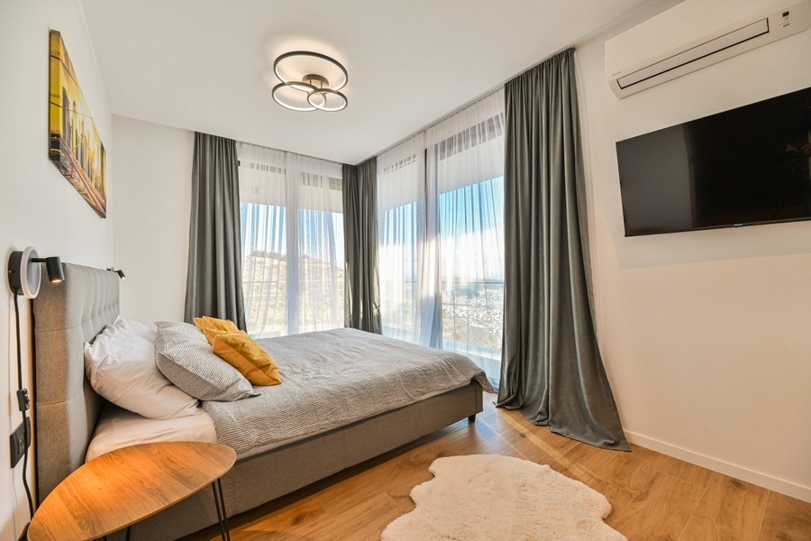 Bedroom with floor-to-ceiling windows and views