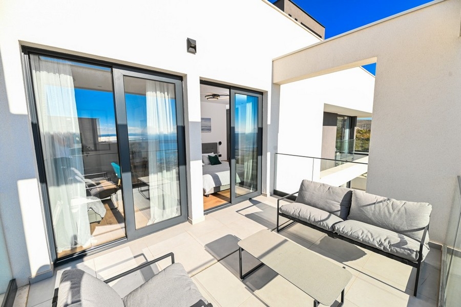 Spacious terrace with seating area and glass front