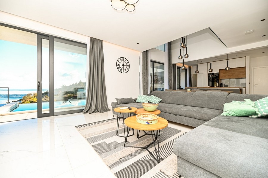 Living room with large windows and pool view