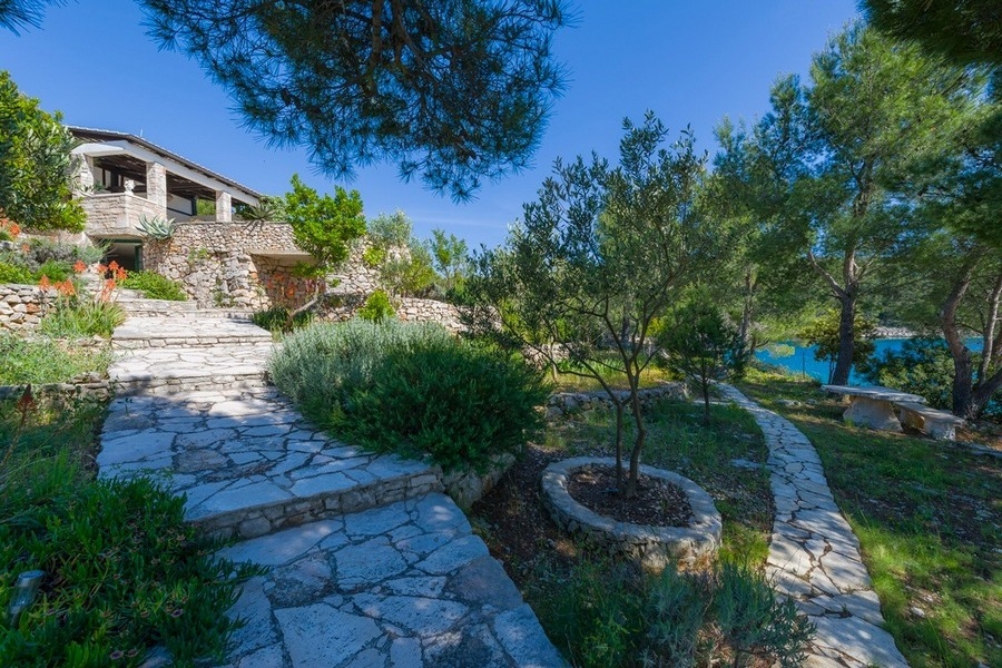 Natural stone terrace with palm trees and coastal views