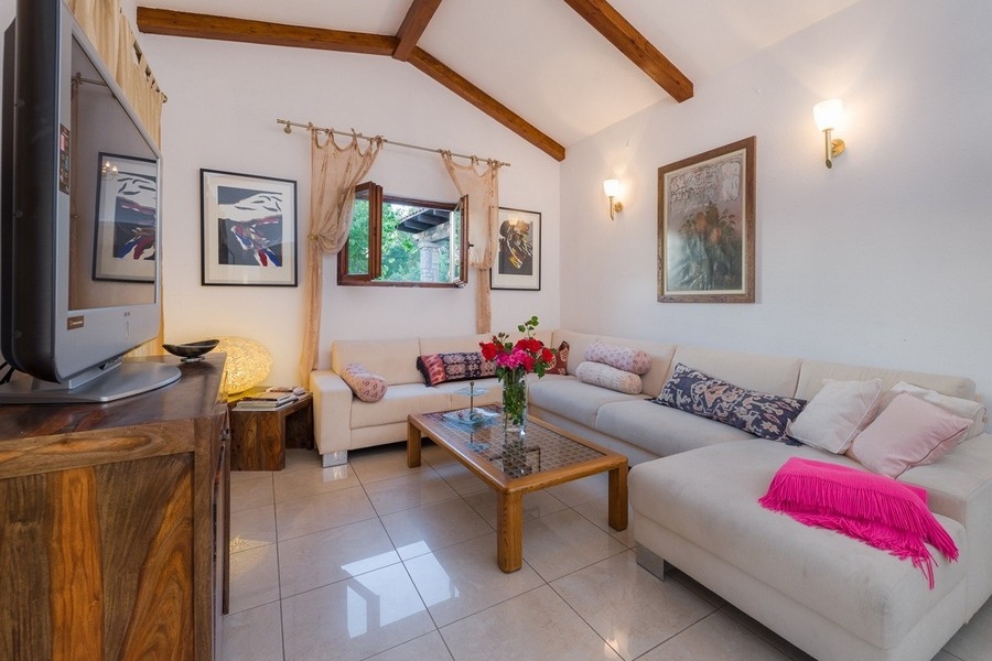 Living room with wooden beams and bright furnishings