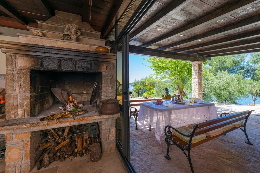 Outdoor fireplace with seating area and ocean views