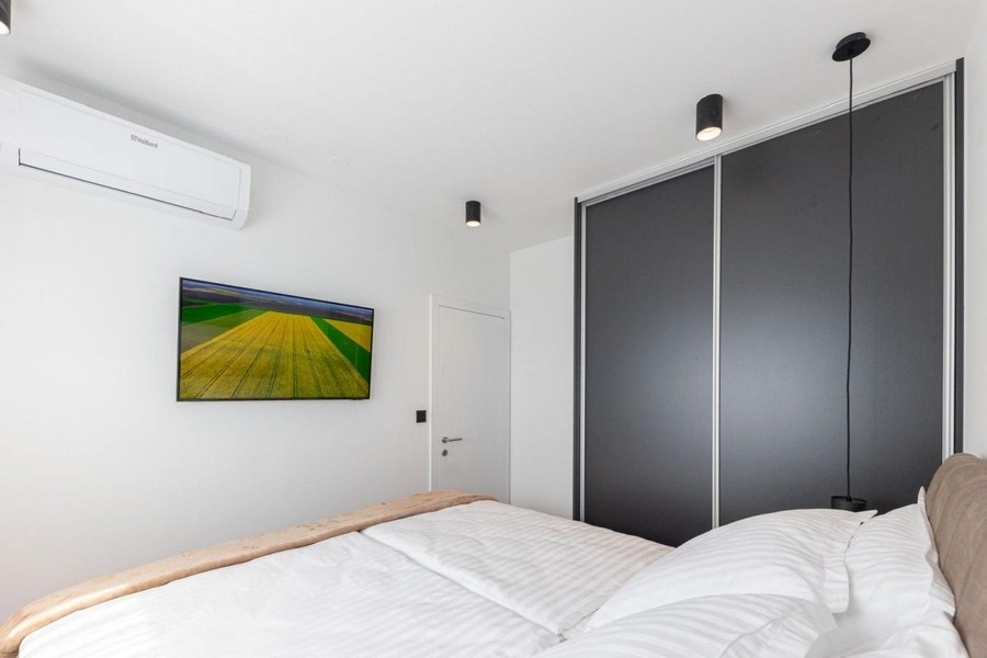 Bedroom with built-in wardrobe and air conditioning