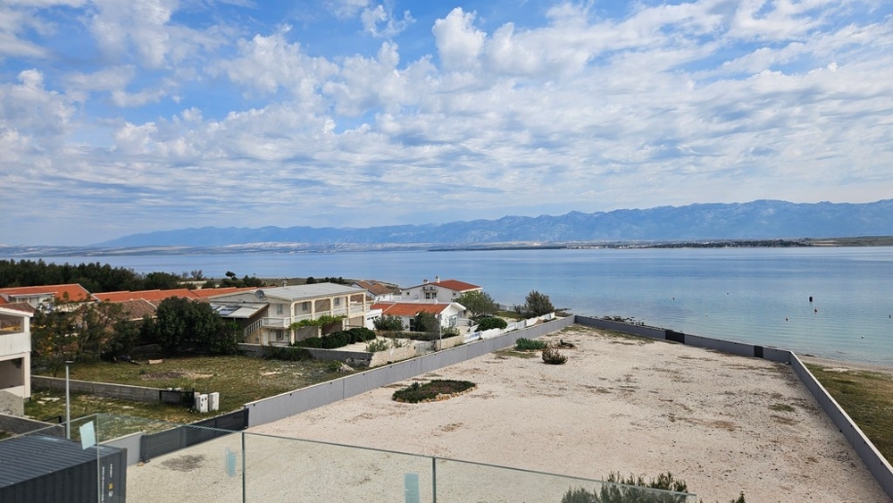 Wide panoramic views over the sea, the island of Pag and the Velebit mountains.