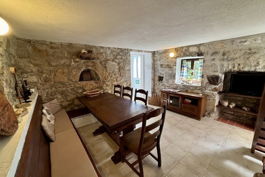 Traditional dining area with natural stone walls in Dalmatian stone house