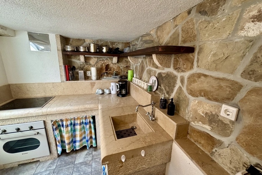 Rustic stone kitchen with Mediterranean character in the renovated village house