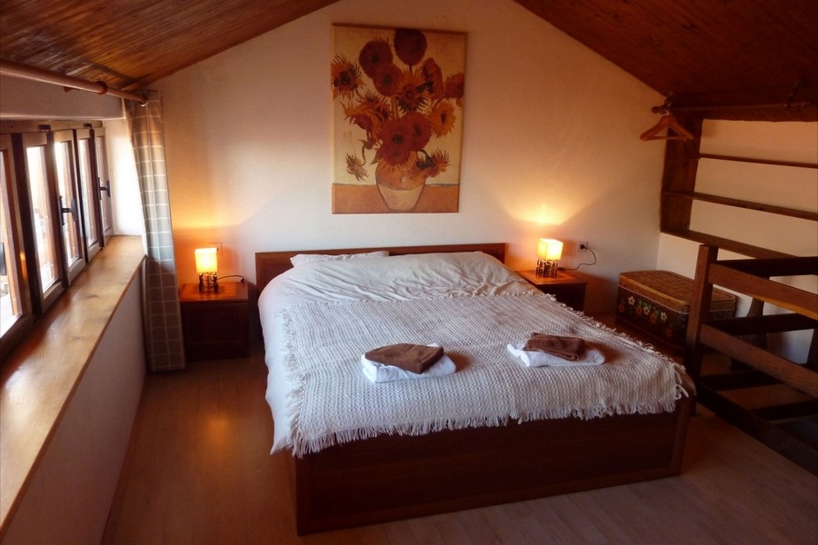 Cozy attic bedroom with traditional wooden ceiling