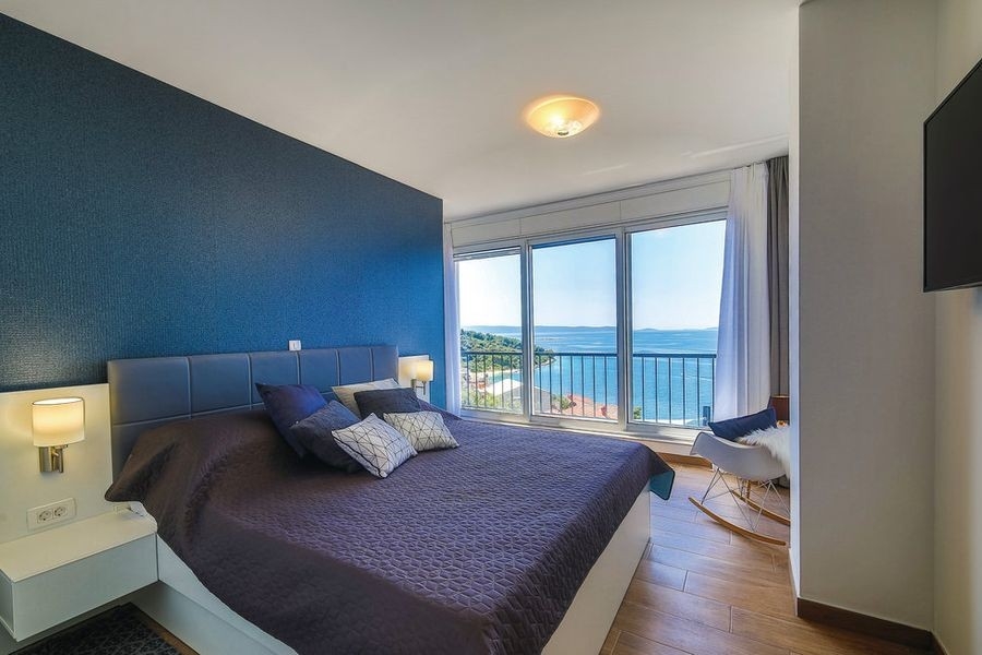 Bedroom with large windows and sea views