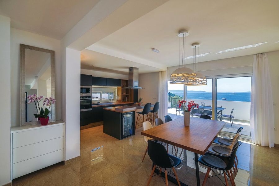 Modern kitchen with dining area and sea views