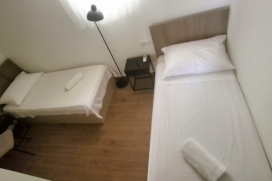 Children's room with two single beds in modern villa