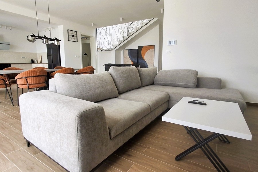 Modern living room with open-plan interior design in new-build villa in Croatia
