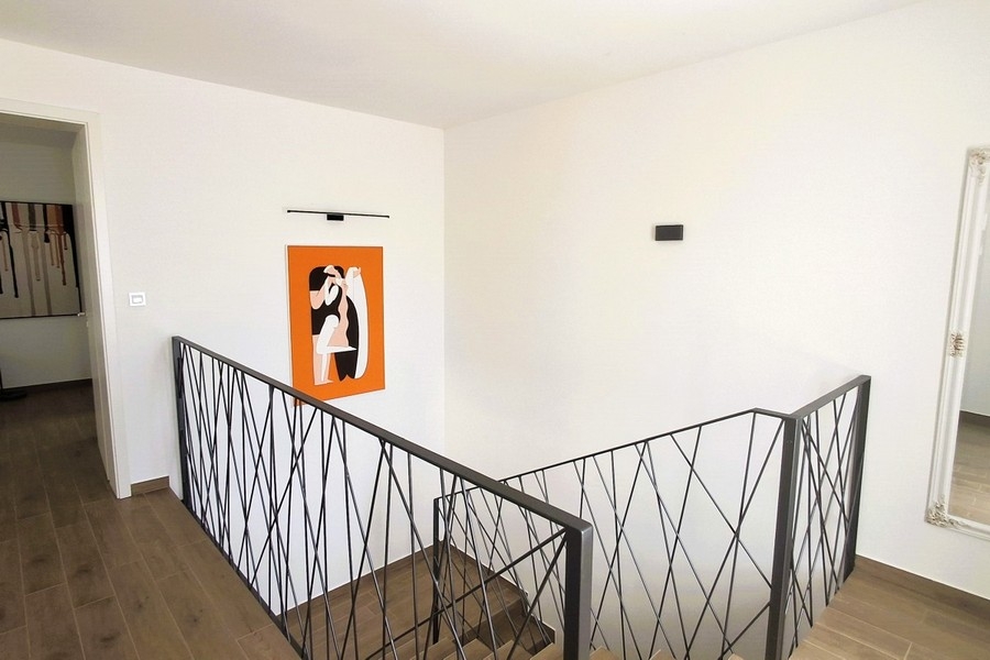 Open gallery on the upper floor of the modern villa