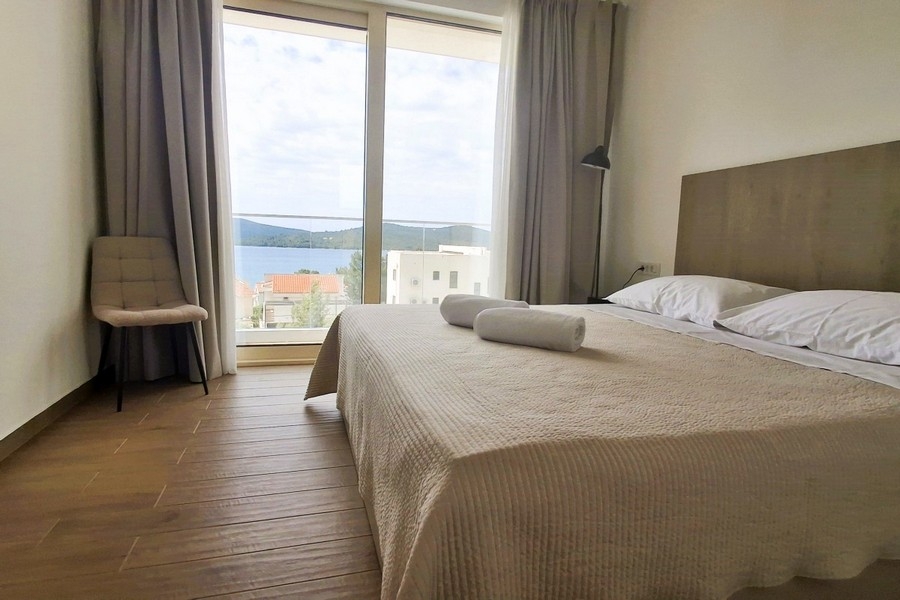 Bedroom with large window and sea view