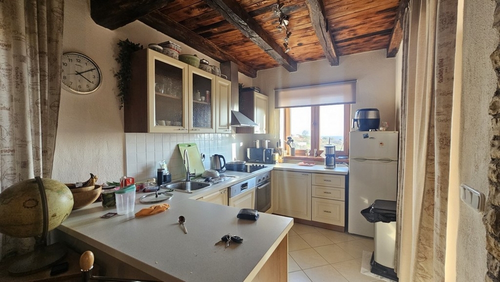 Mediterranean-style kitchen with beamed ceiling