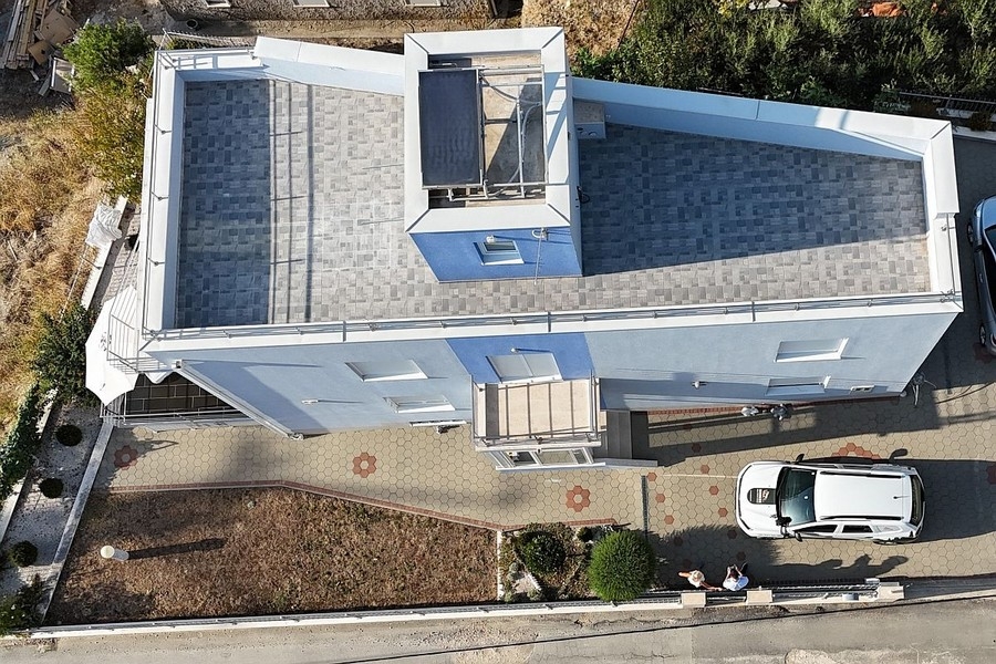 Aerial view of a house with a roof terrace
