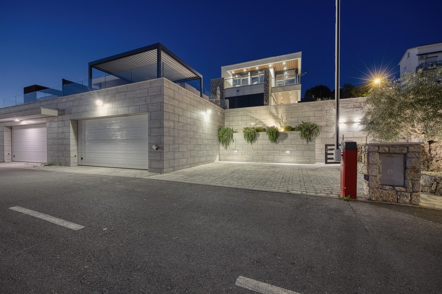 Villa at night with garage and illuminated outdoor area
