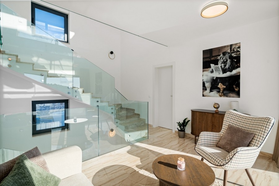 Elegant lounge area with glass railings and modern interior