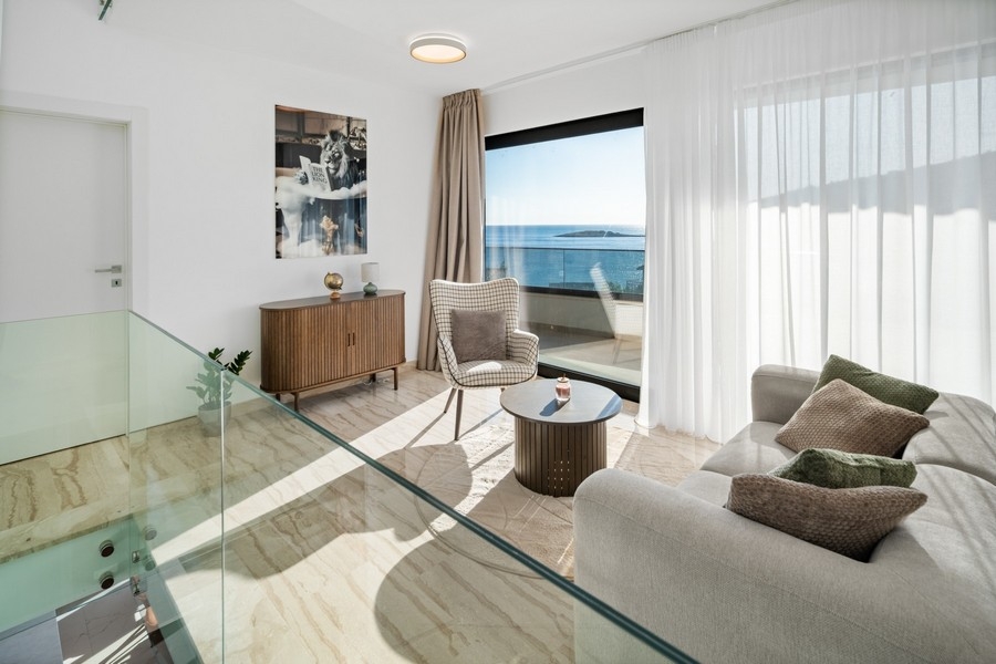 Seating area with sea views and large window front in the villa