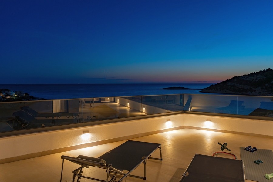 Roof terrace with unobstructed sea views and modern outdoor lighting