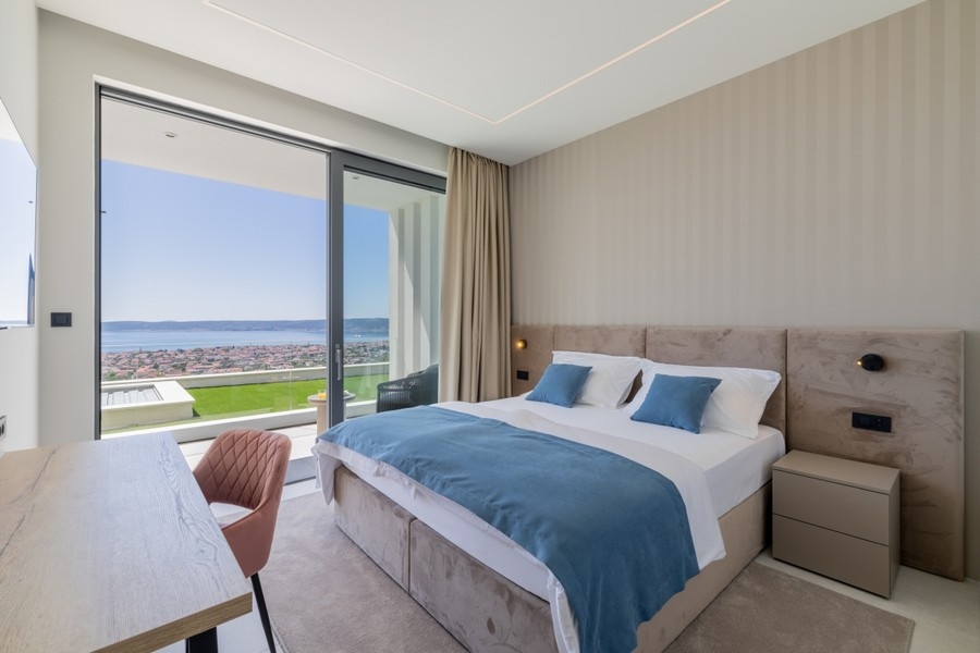 Bedroom with panoramic windows and sea views