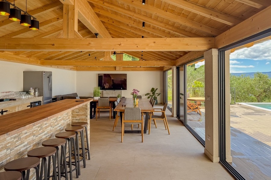 Open plan living area with pool access and sea views