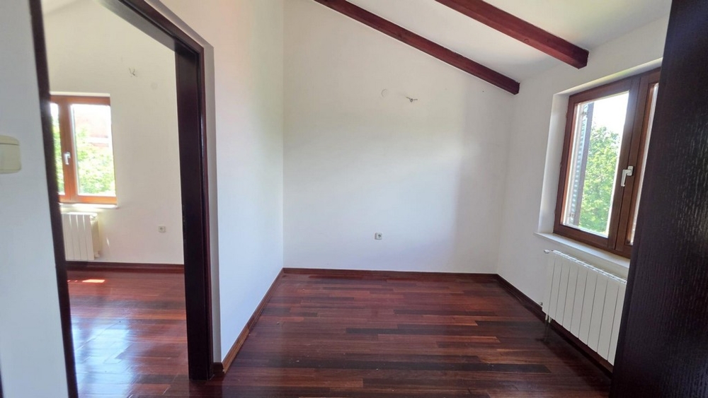 Bedroom with wooden floor and window