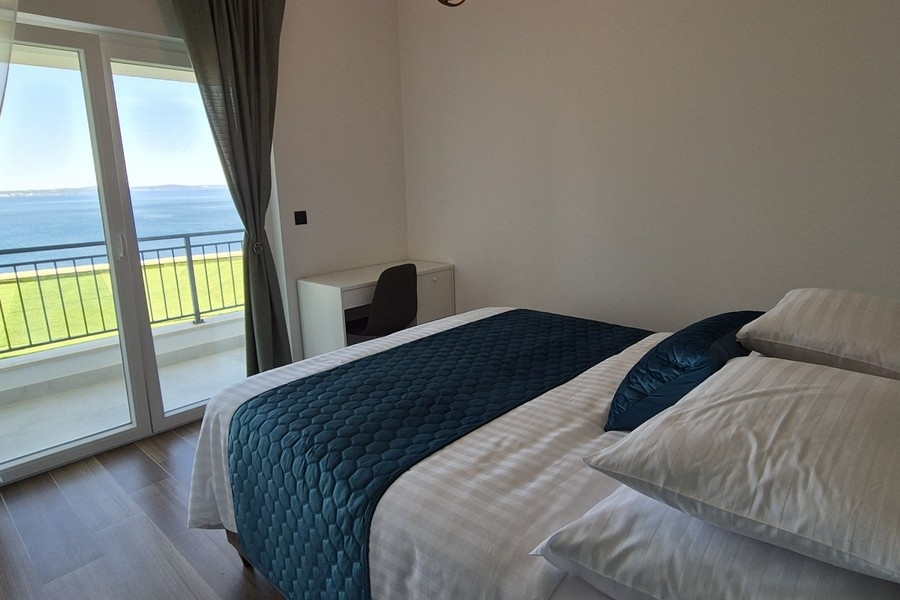 Bright bedroom with balcony and sea view