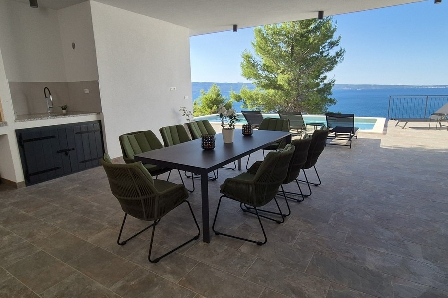 Covered terrace with outdoor kitchen and sea views
