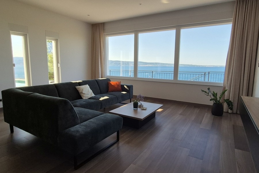 Living room with large window front and sea view