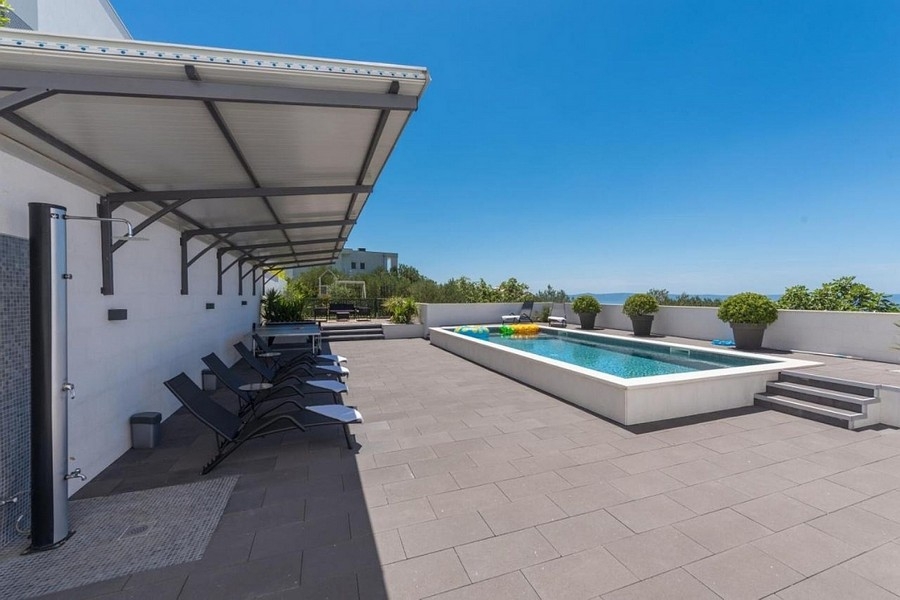 Sun terrace with pool and sunbathing area