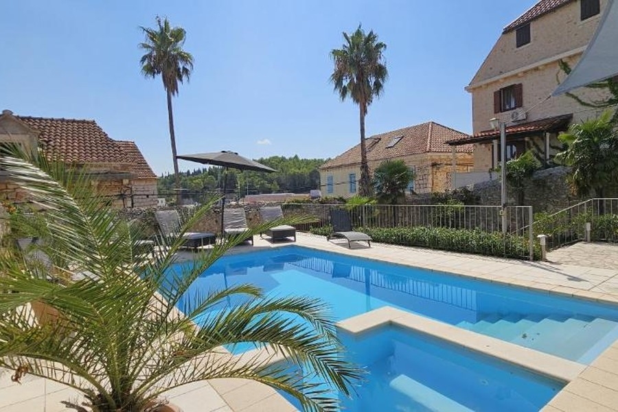 Pool area with Mediterranean stone villa