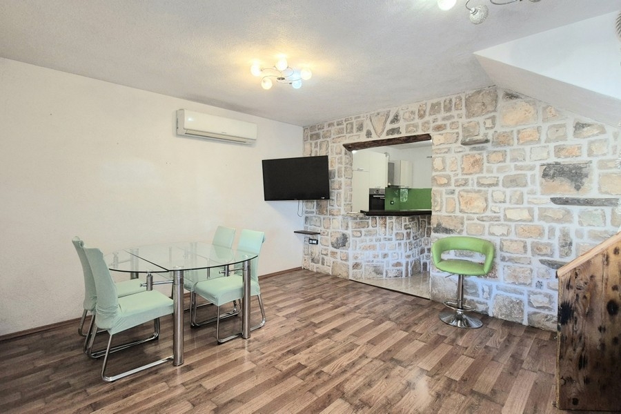 Living and dining area with stone wall